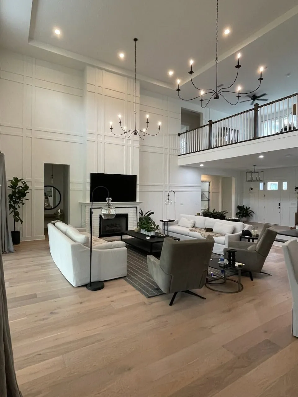Two-story living room with white board-and-batten walls