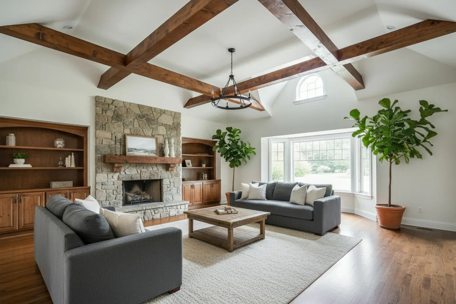 Great room with stained wood box beams crossing a high white ceiling