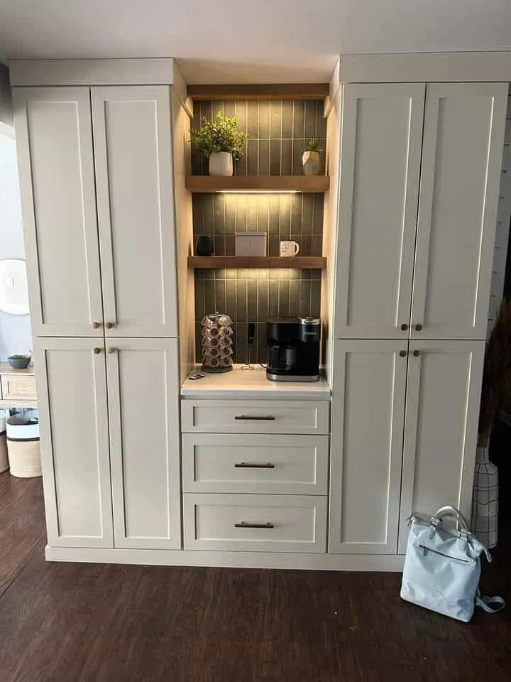 Built-in coffee bar with white shaker cabinets and tile backsplash