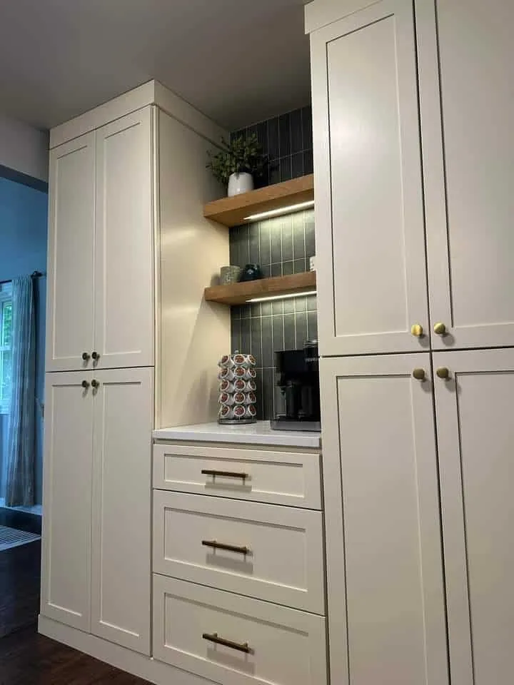 Custom painted cabinetry with glass upper doors and drawer banks in a Jacksonville kitchen