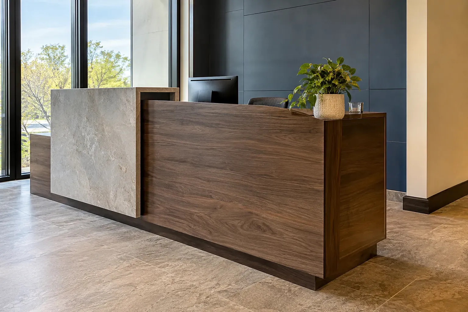 Modern reception desk with walnut front panel and stone-look waterfall block against a navy paneled wall