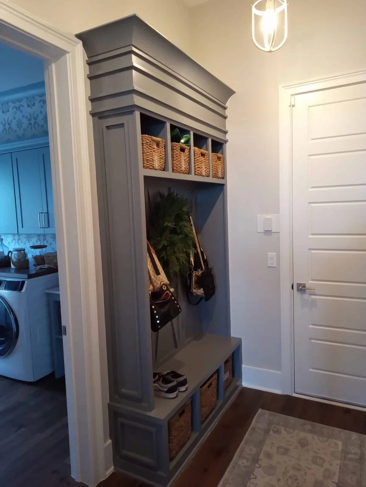 Blue-gray mudroom locker with cubbies, coat hooks and bench storage