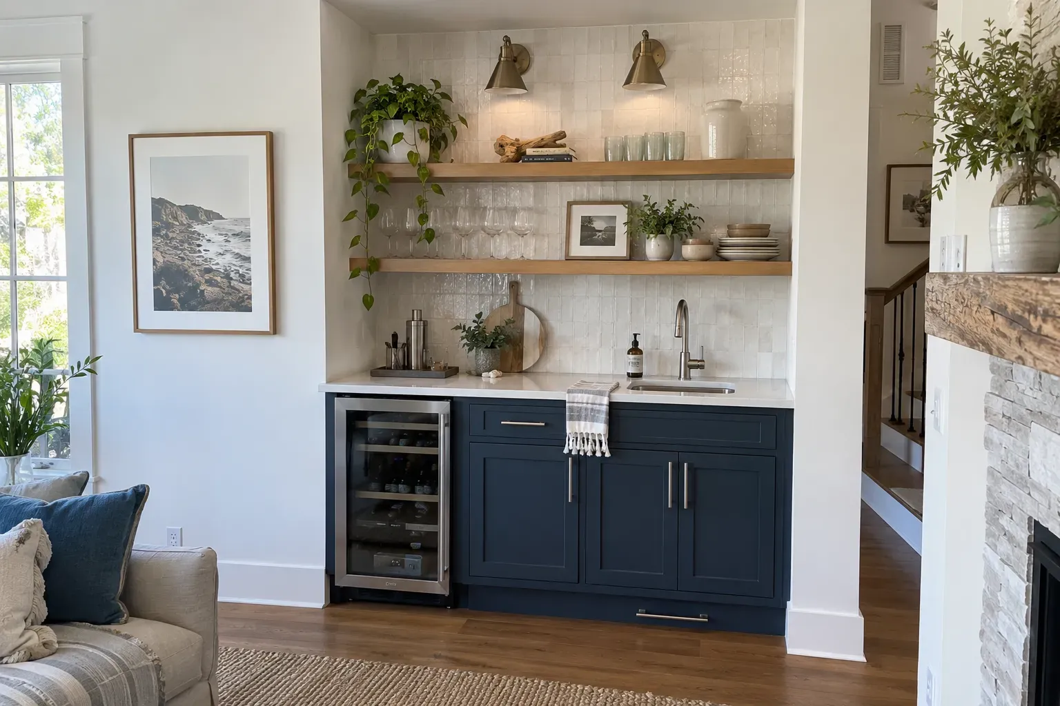 Navy shaker dry bar in a living room alcove with oak floating shelves, white tile backsplash and a wine fridge