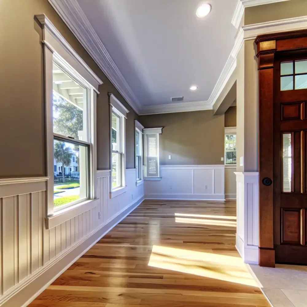 Wide painted window casing and a stained door frame along a hallway